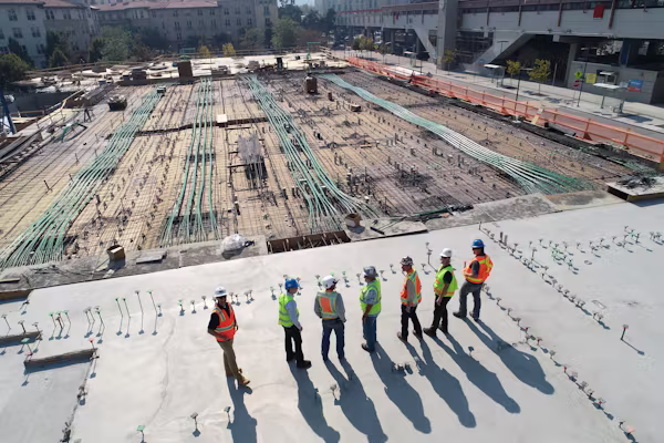 Engineering team reviewing construction plans on site